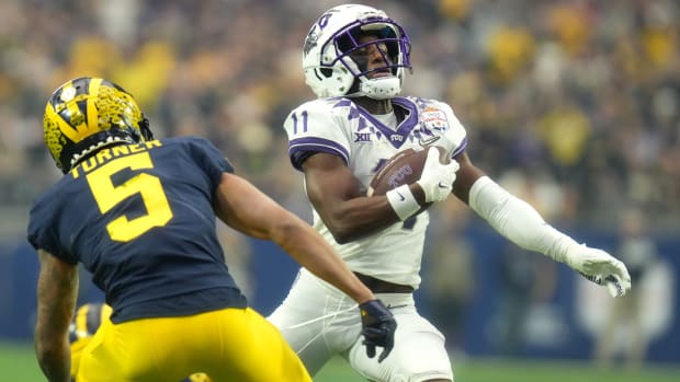 Dec 31, 2022; Glendale, Arizona, USA; TCU Horned Frogs receiver Derius Davis (11) runs past Michigan Wolverines defensive back DJ Turner (5) during the Vrbo Fiesta Bowl at State Farm Stadium. Mandatory Credit: Joe Rondone-Arizona Republic Ncaa Fiesta Bowl Game